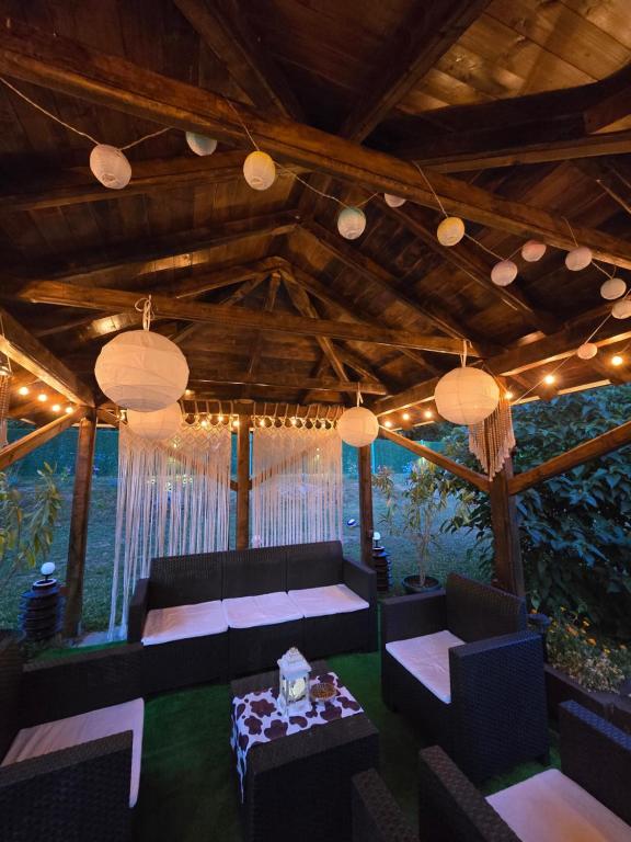 a room with couches and a table and lights at Vikendica Fruškogorski kutak - Fruška Gora in Čerević