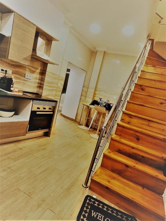 a kitchen with a staircase leading up to a kitchenasteryasteryasteryasteryasteryastery at Vivenda da Tendeirinha in Arrentela