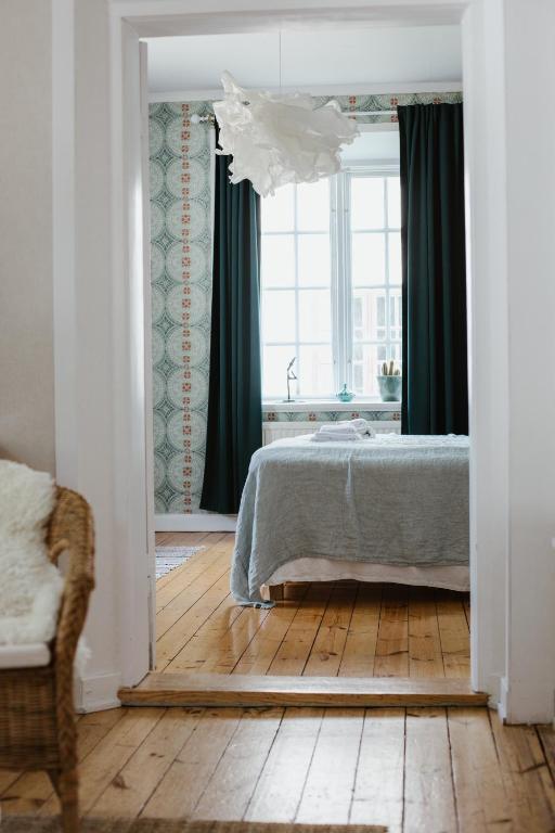 a bedroom with a bed and a large window at STF Gysinge Wärdshus & Hotell in Gysinge