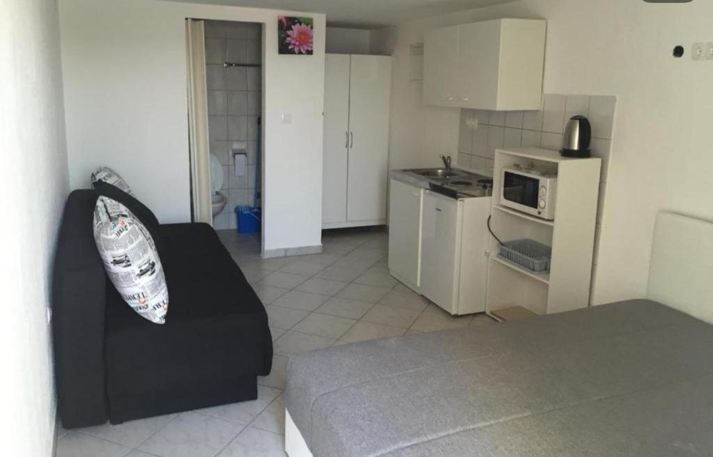 a living room with a couch and a kitchen at villa Niki in Crikvenica