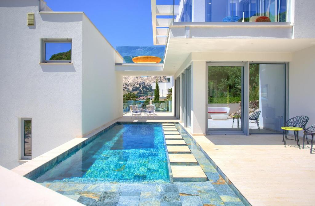 a swimming pool in the backyard of a house at The Oscar in Baška