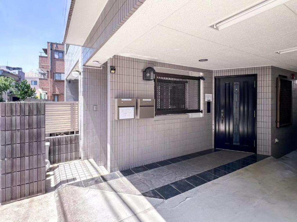 an outside view of a building with a black door at 渡边ビル402 in Tokyo