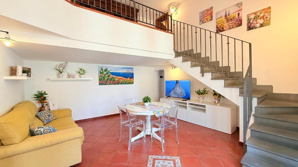a living room with a table and a staircase at Luna Prime Collection Catania in Catania