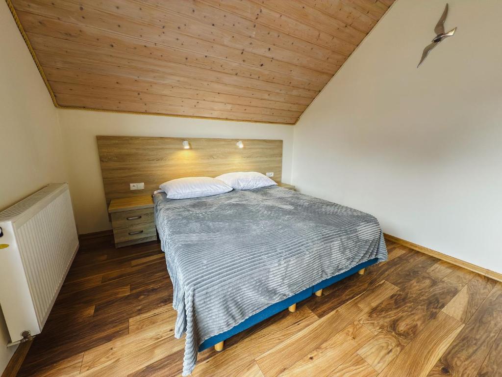 Posteľ alebo postele v izbe v ubytovaní Rellim Apartamenty