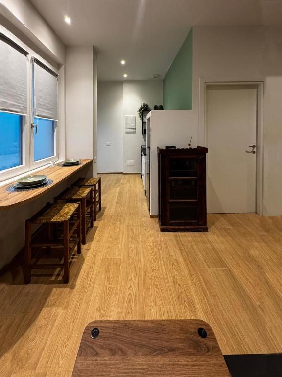a kitchen with wooden floors and a white refrigerator at Appartamento Bianca in Prato