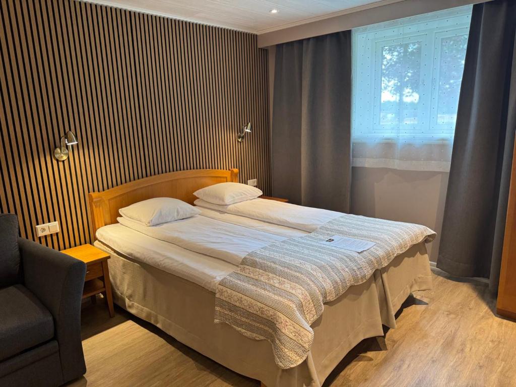 Postel nebo postele na pokoji v ubytování Hotel Tanum Gestgifveri