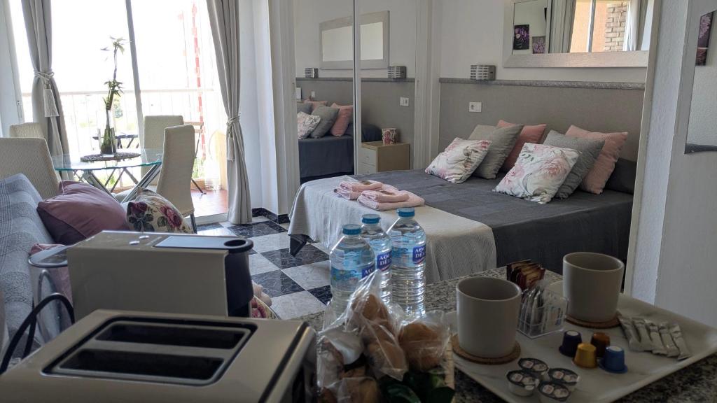 a room with a bed and two bottles of water at Suite Refugio Aconcagua - Benalmádena España in Benalmádena