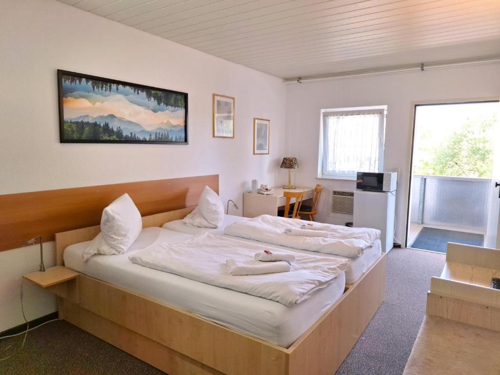 a bedroom with a bed with a woman laying on it at Hotel Spilburg in Wetzlar
