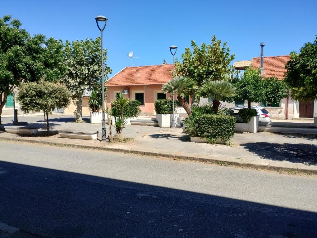 a street with a house and trees on the side of the road at Agorà 1 in Parghelia