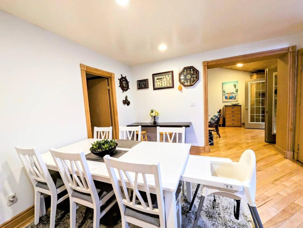 a dining room with a white table and chairs at Lakeside Cottage 12 Guests Gated 2 cottage in Lambton Shores