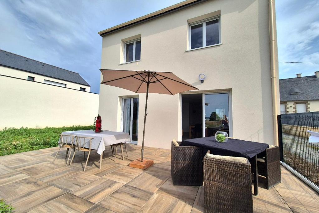 a patio with a table and an umbrella at Beautiful 3 bedroom house close to the sea in Cherrueix