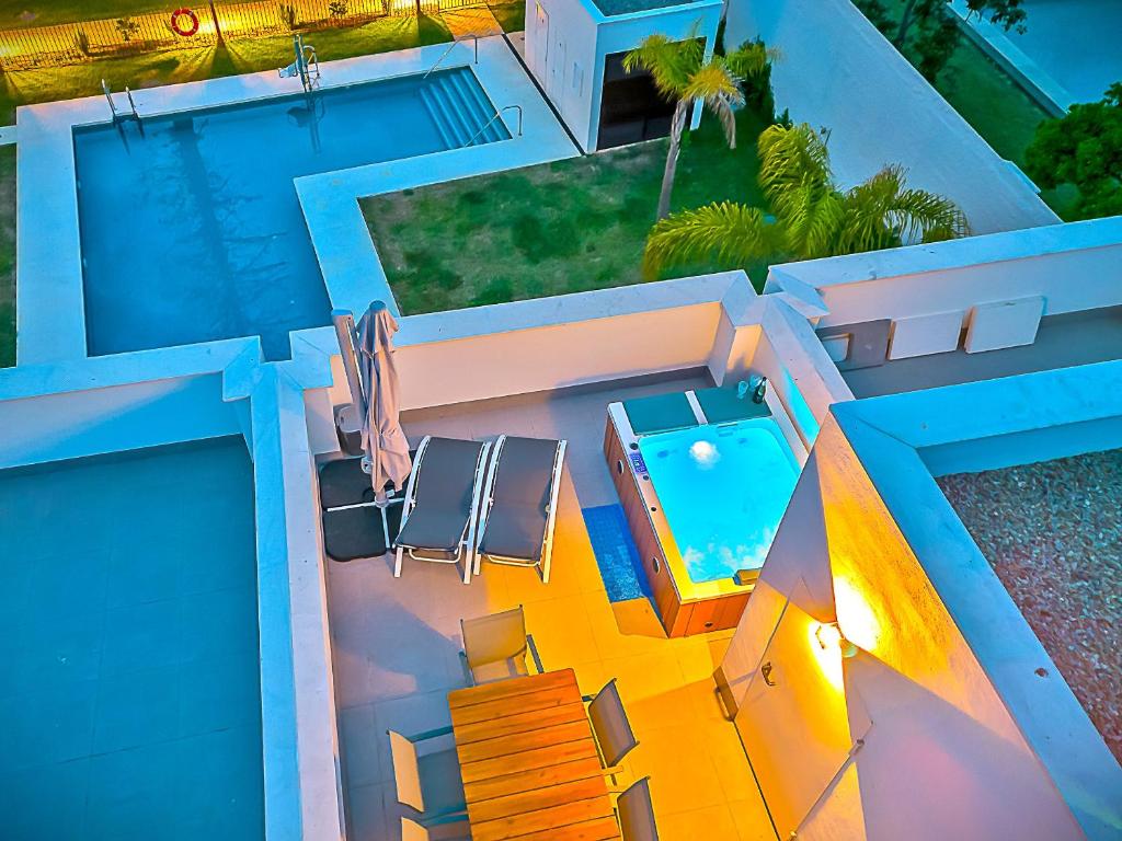 an aerial view of a house with a swimming pool at Jacuzzi & Pool House w Rooftop Terrace, Garden BBQ in El Puerto de Santa María