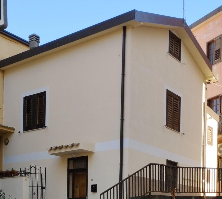 a white house with a black roof at San Giovanni Apartment in Catanzaro