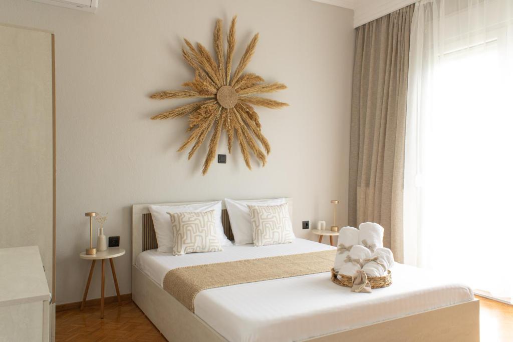 a bedroom with a bed with a clock on the wall at Helen's Cozy Stay in Chrysoupolis