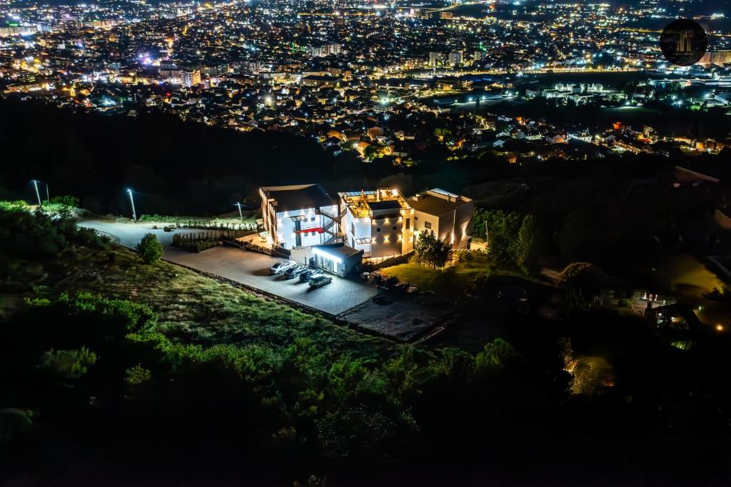 a view of a city at night at Villa Alpha Familiare in Prizren