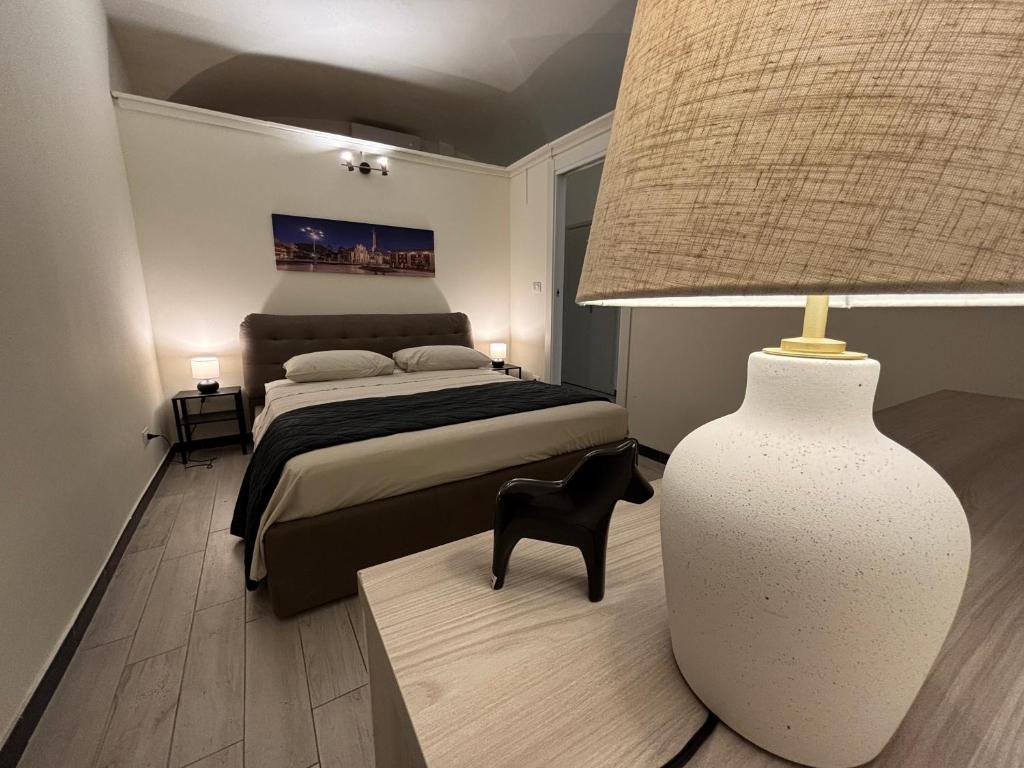 a bedroom with a bed and a lamp and a table at Agata dreams apartment in Catania