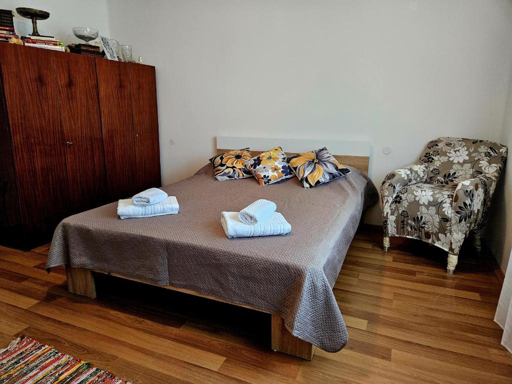 a bedroom with a bed with two towels on it at Green Haven Retreat - Nature's peace just for you in Rakovac