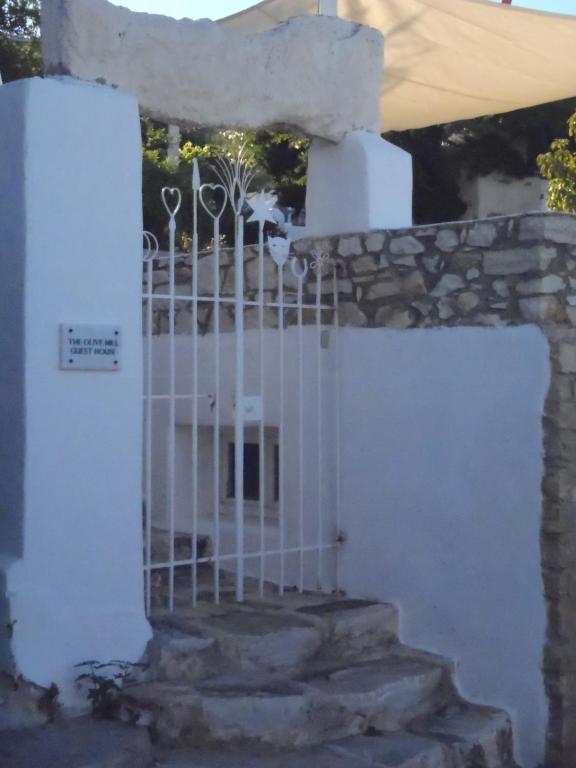 a gate in a building with a stone wall at THE OLIVE MILL GUEST HOUSE in Lefkes