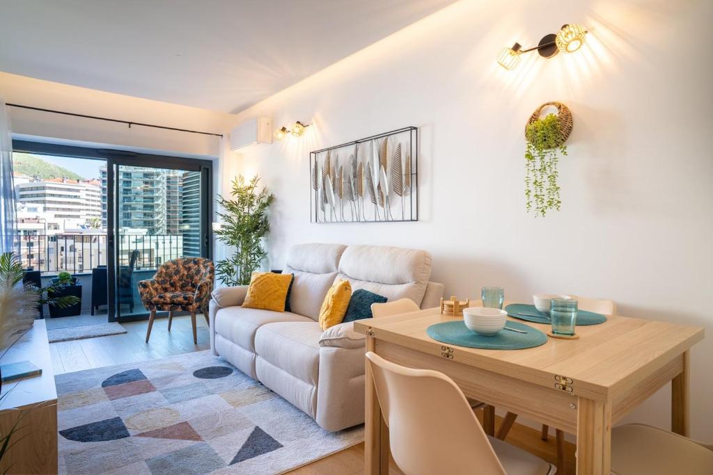 a living room with a couch and a table at GuestReady - Soothing escape in Funchal in Panasqueira
