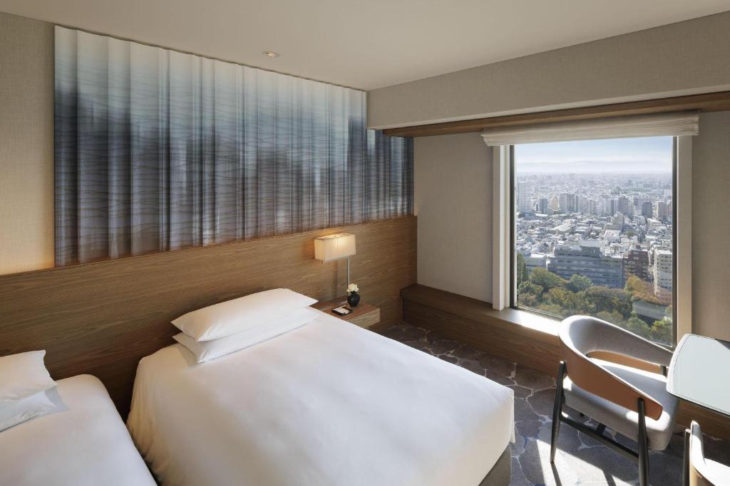 Postel nebo postele na pokoji v ubytování Hyatt Regency Tokyo