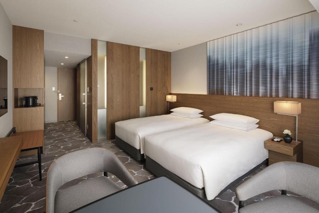 Postel nebo postele na pokoji v ubytování Hyatt Regency Tokyo