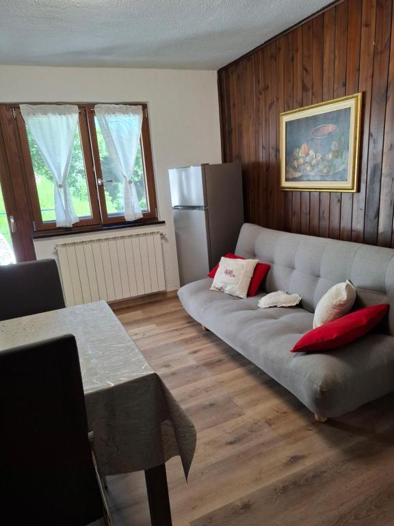 a living room with a couch and a refrigerator at Petit Maison - Valtournenche in Valtournenche