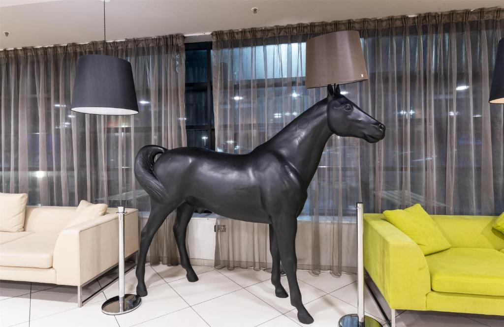 a statue of a horse in a living room at Hampton by Hilton Liverpool John Lennon Airport in Speke