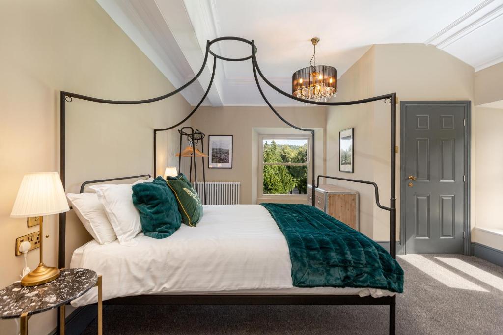 a bedroom with a large bed and a chandelier at The Scarborough Suite in Marske