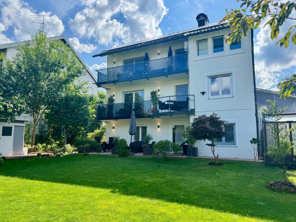 a large white house with a yard at Schwarzwald Ferienwohnung in Freudenstadt