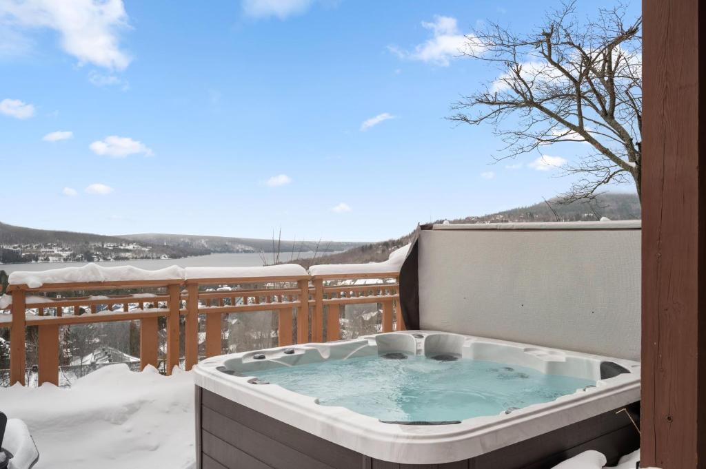 a jacuzzi tub on a balcony with snow at Tremblant Prestige - Altitude 170-2 in Mont-Tremblant