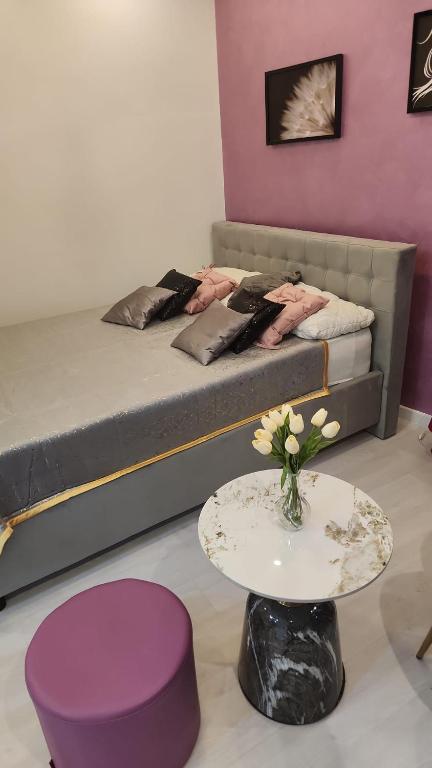 a room with a bed and a table and a table sidx sidx sidx at Ultra Central White & Lila Studio in Bucharest