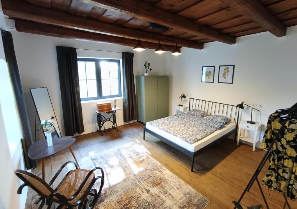 a bedroom with a bed and a table and chairs at HÁRS meg az alja in Balatonszárszó