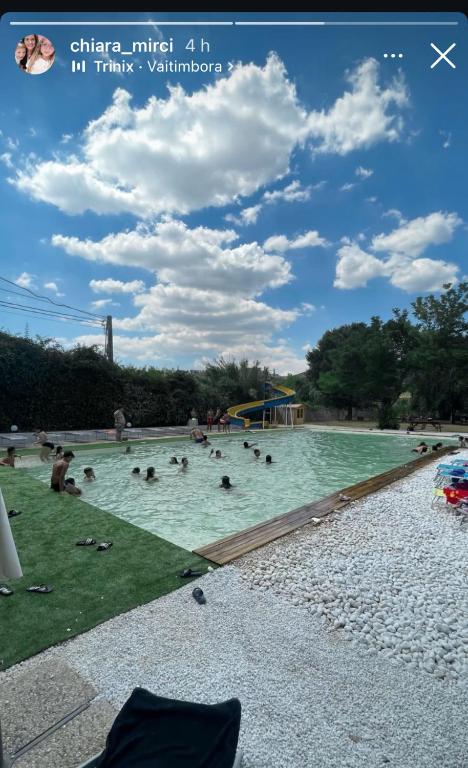 a group of people swimming in a swimming pool at B&B RosAngelo in Mirabella Imbaccari