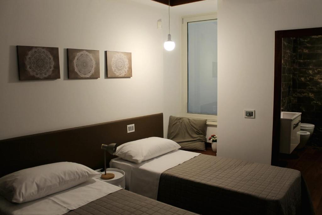 Postel nebo postele na pokoji v ubytování OroVerde Rooms & Suite nel cuore di Trani