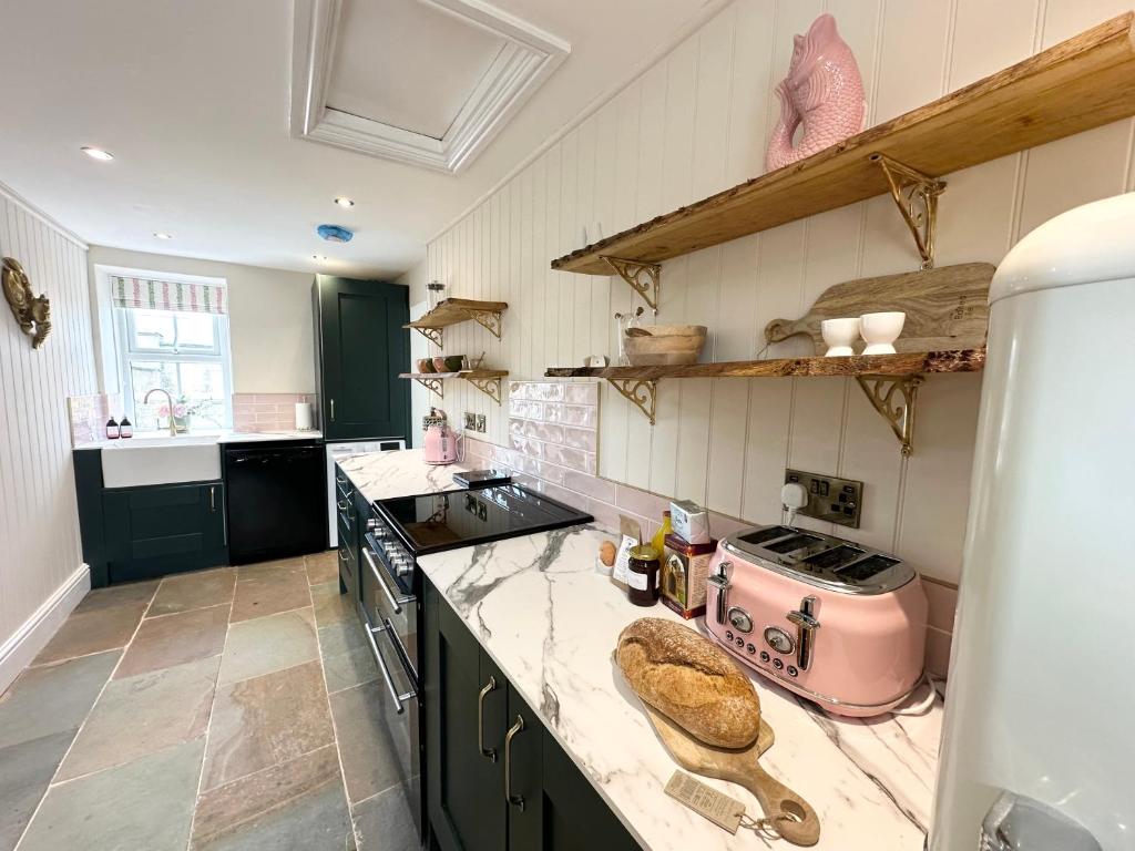 a kitchen with a pink appliance on a counter at Mill Cottage in Newlands