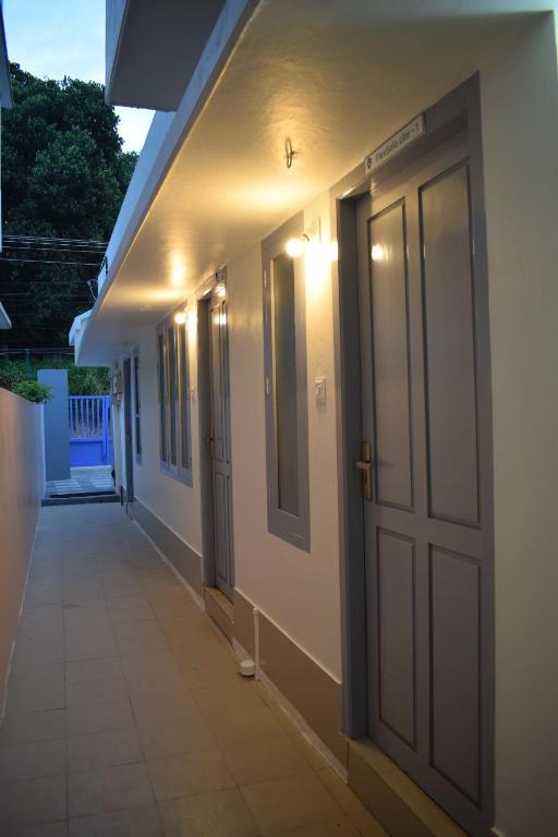 a hallway of a house with a door and lights at FlexTays Campus - Budget Student Stays in Trivandrum