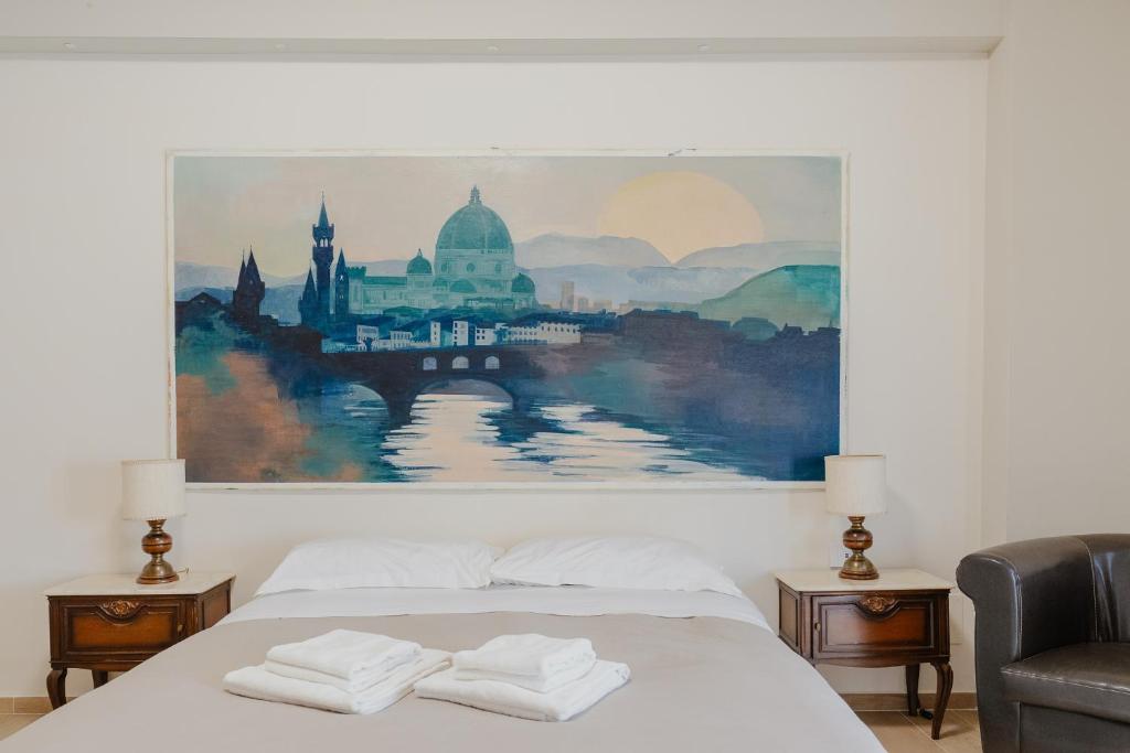 a bedroom with a bed with two folded towels on it at Duomo - Camere matrimoniali con bagno privato in Florence