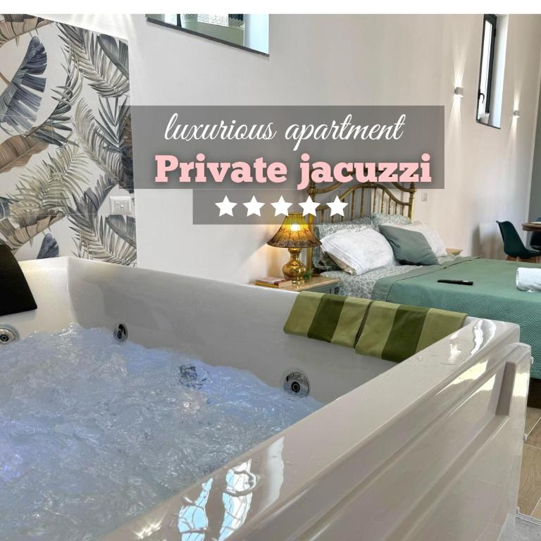 a bathtub in a room with a sign that apartment private lagoon at Dimora Lilly in Acireale