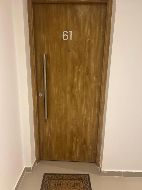 a wooden door with the number on it at Departamento Funcional ll Punto Alquiler in Santiago del Estero