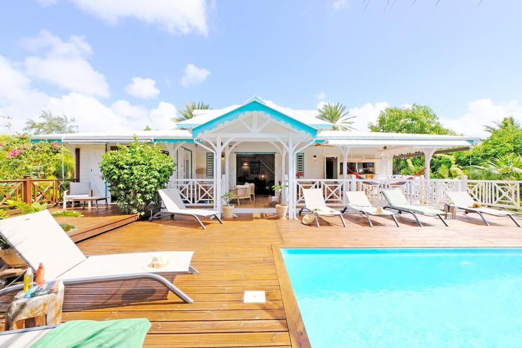 a patio with chairs and a swimming pool at Charming villa with swimming pool for 6-8 in Saint-François