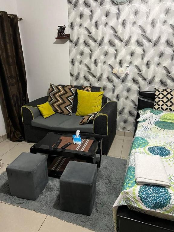 a living room with a couch and a coffee table at Residence Madison in Abidjan