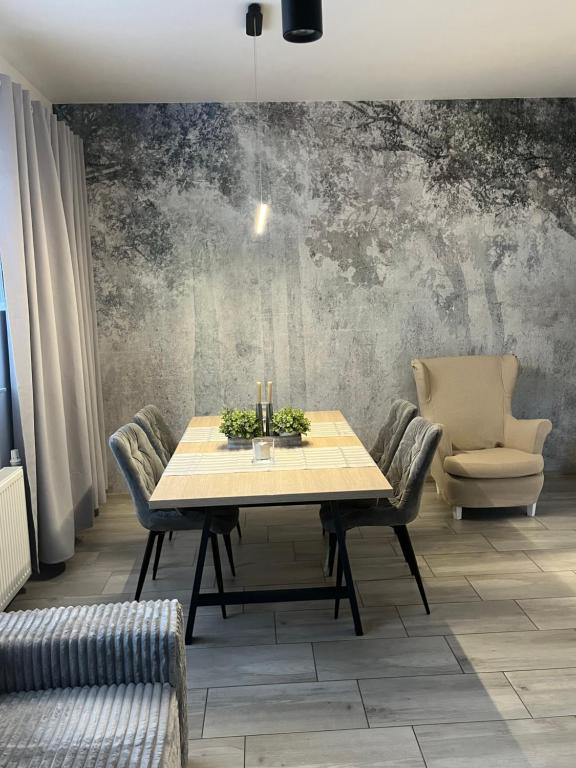 a dining room with a table and chairs at Apartament Olesno Lux in Olesno