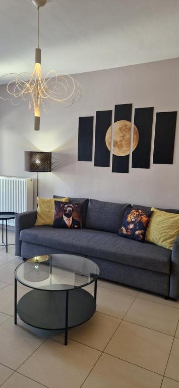 a living room with a blue couch and a table at Grey House in Prinos