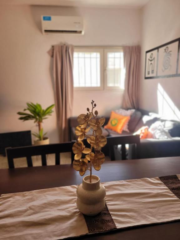 a living room with a table with a flower on it at Casa Oliva in Tinogasta