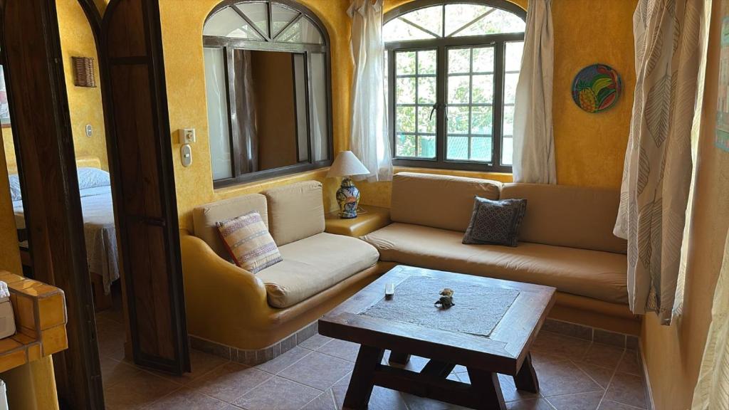a living room with a couch and a table at Botanical Studios Sayulita in Sayulita