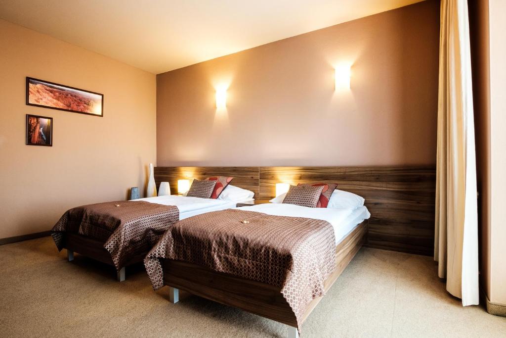Postel nebo postele na pokoji v ubytování Hotel Comfort with free Wellness and Fitness Centrum