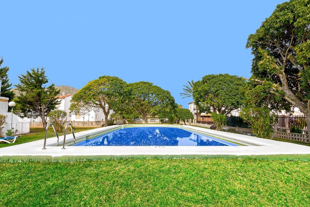 a swimming pool in a yard with trees at Apartment Rosmare in Alcudia