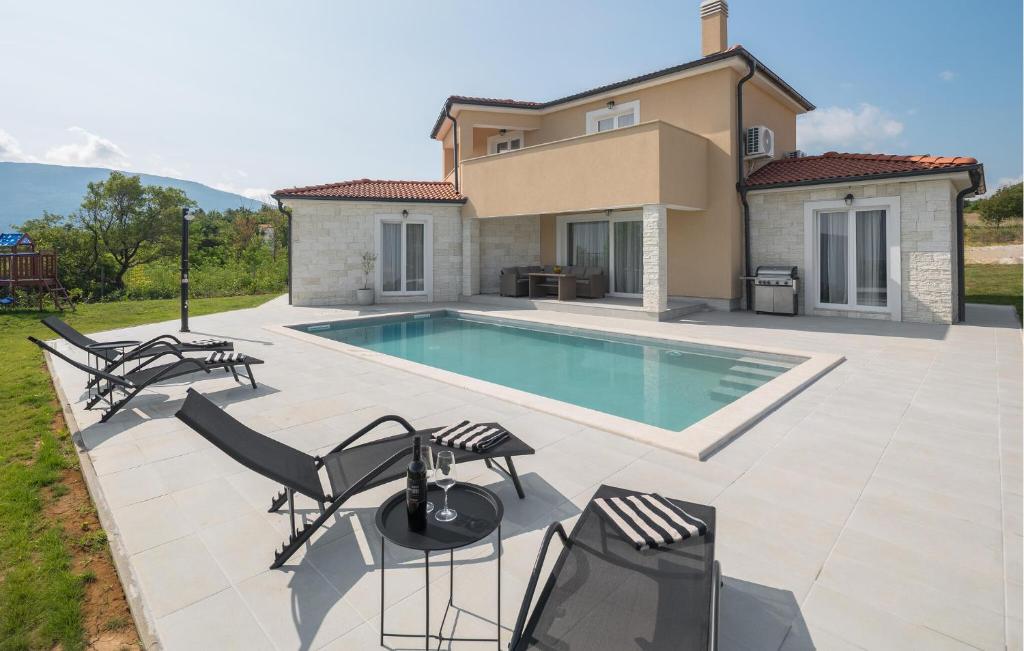 a villa with a swimming pool in front of a house at Amazing Home In Krsan in Kršan