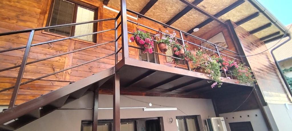 a building with a balcony with potted plants on it at Centar in Valjevo