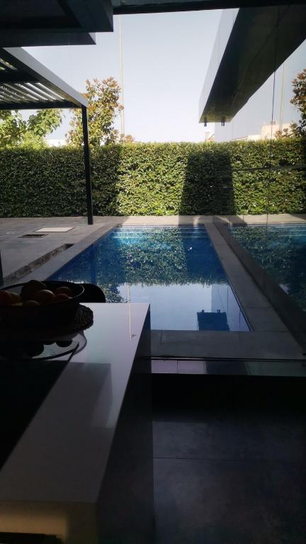 a swimming pool in a house with a pool at Black Box village with garden in Seferihisar